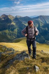 Fototapeta na wymiar Hiker with backpack on mountains