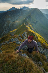 Hiker with backpack on mountains