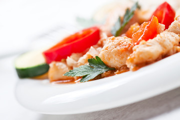 Homemade stewed fish with vegetables and rice, closeup, selective focus