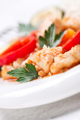 Homemade stewed fish with vegetables and rice, closeup, selective focus.