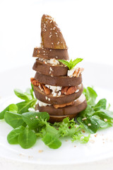Baked pear with cheese, nuts and honey on a salad, closeup, selective focus