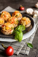 Mushrooms stuffed with rice, tomato, pea, corn and topped with mozzarella