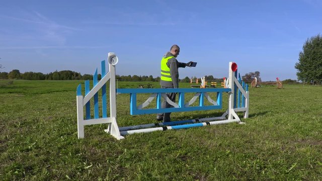Horse handler take picture of hurdle