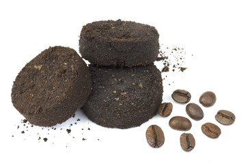 Used coffee grounds after espresso machine and coffee beans on white background.