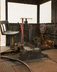 Old steam locomotive cab interior with red and rust