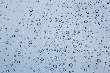 Rain drops on a car hood silver