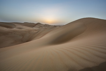 Fototapeta na wymiar sunset over sand dunes of Empty Quarter desert