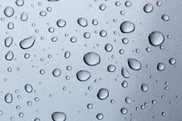 Rain drops on a car hood silver