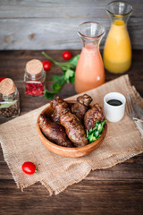 Beef stuffed with mushrooms in a bowl on a wooden table