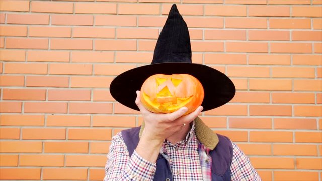 Young man with Jack latern pumpkin