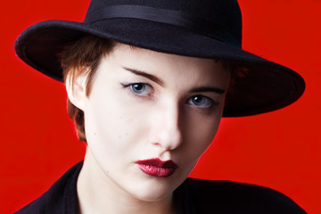 Studio portrait in front of red background of woman