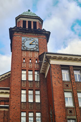 The building with the clock tower of red brick in Poznan.