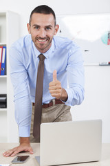 Fototapeta premium Happy businessman working in his office on the laptop