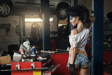 Fototapeta na wymiar Woman mechanic in the garage