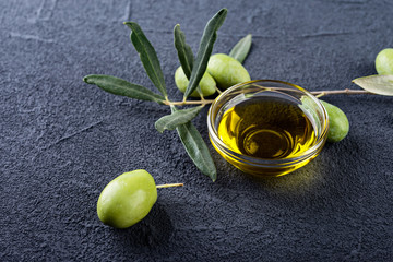 Olive branches and oil on a dark  background