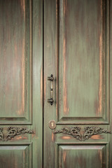 beautiful vintage door with ornament and iron handle