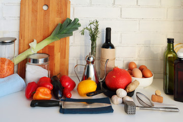 Cooking and kitchen concept. White kitchen table with food products, cooking ingredients and kitchen utensils. Copy space. Selective focus. 
