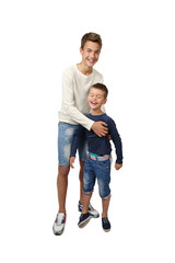 Happy teenage boy plays with his joyful little brother isolated on white background