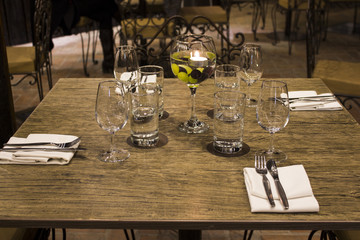 Wine glasses with napkins, glasses and gourmet food, banquet table. 