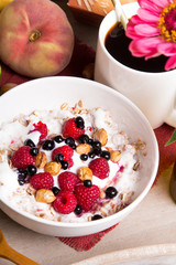 Tasty breakfast: oatmeal with yogurt and fruit on a wooden tray