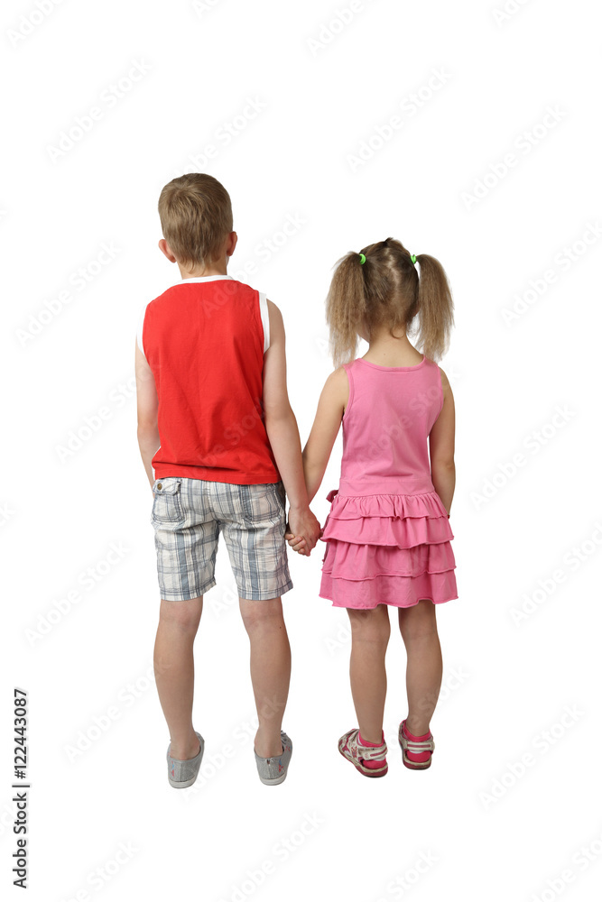 Wall mural Boy and girl stand back holding hands isolated on white background