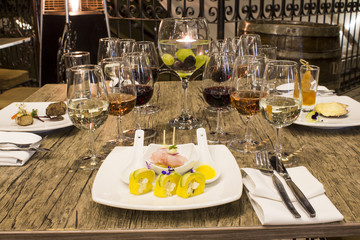 Wine glasses with napkins, glasses and gourmet food, banquet table. 