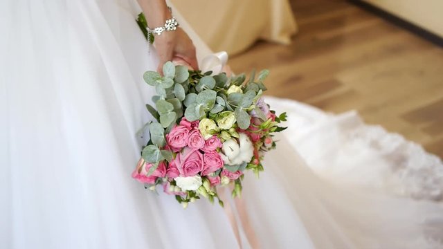 Bride holding wedding bouquet in hands 2