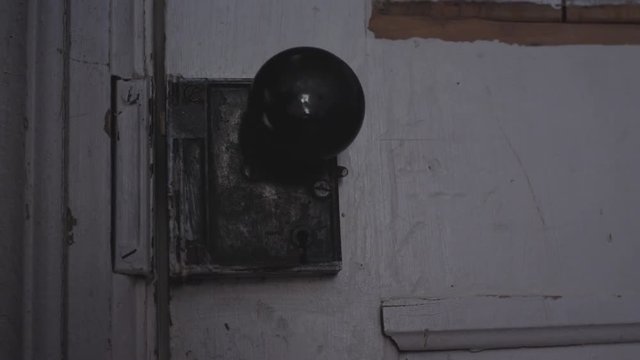 Something trying to open an old door