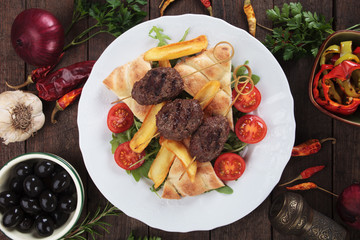 Kofta kebab with pita bread and french fries