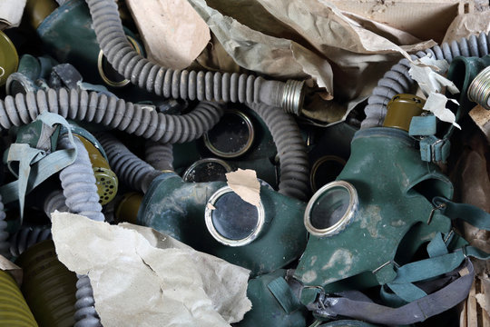 Old gas masks close up in abandoned bomb shelter - civil defense and survival concept