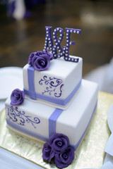 Beautiful wedding cake for bride and groom indoors. Colorful pie for celebration. Beauty of bridal interior for marriage