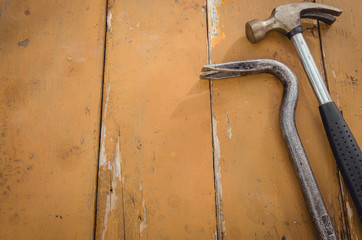 industrial tools/the hammer and nail catcher on a wooden background