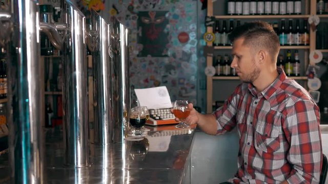 Handsome Man In Pub Drinking Beer Degustating different beers. Stout Ale and Porter in Cafe.