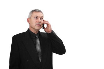 Middle age man in business black suit calls by mobile phone isolated on white background with copy space on right