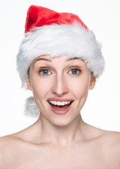 Fototapeta premium Beautiful happy woman in christmas santa hat