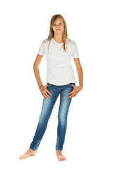 Fototapeta premium Young girl standing barefoot with white t-shirt and blue jeans over white background