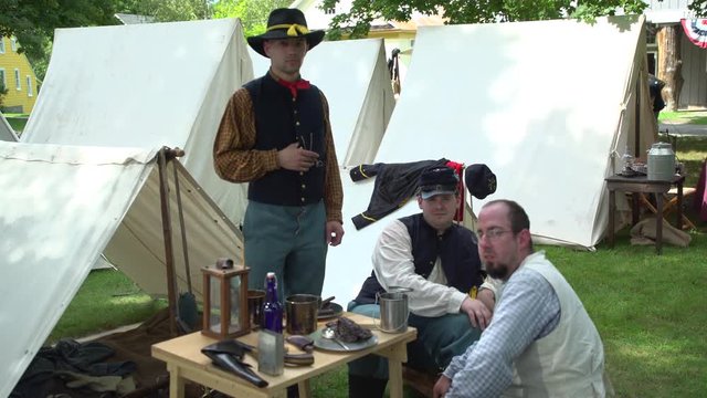 Civil War soldiers pose in an encampment