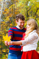 couple playing with leaf in autumn park