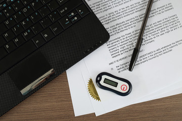 Offshore finances and online banking security concept - digital password generation device with pen lies over standard "power of attorney" document near notebook on writing desk