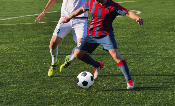  playing football soccer game on sports field