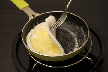 Preparing Brazilian food Tapioca de queijo.