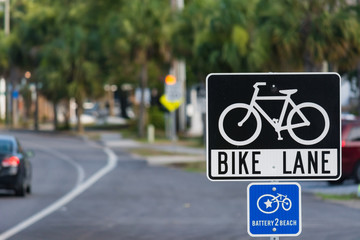 Bike lane sign on the side of a road in Folly Beach. 