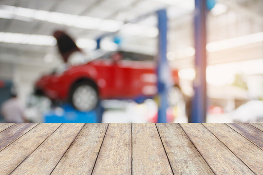Wood table top with blur car service centre background