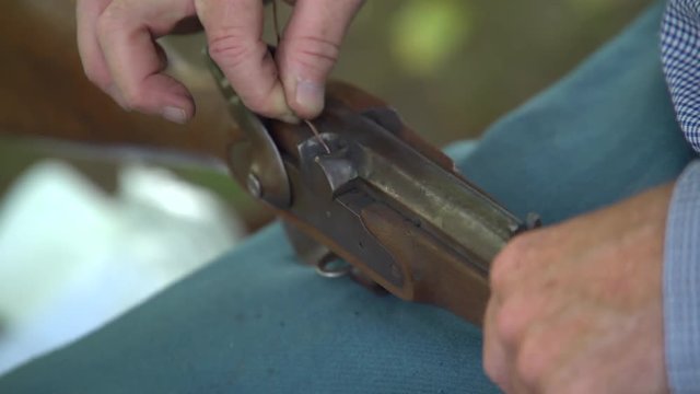 Civil War soldier cleans the pan of his gun