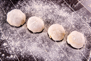 Cook preparing dough for baking in the kitchen