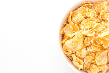Cornflakes in a bowl, isolated on white background, Top view with copy space.