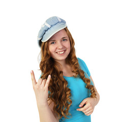 Young pretty redhead girl in cap shows heavy metal gesture isolated on white background in square - beautiful groupie
