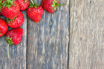 Fresh strawberries on old wooden background