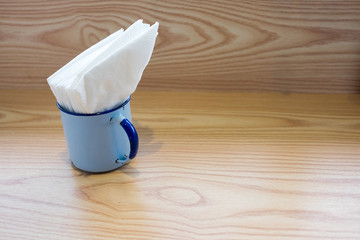 A cup of tissue on table in the background of car parking in the morning with copy space.
