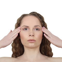 Fototapeta premium Beauty, makeup, skin care concept - Young pretty woman makes facial massage isolated on white background